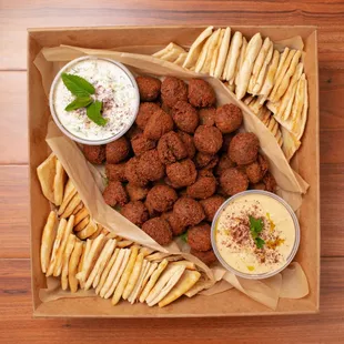 Large Falafel Catering Tray: 50 falafels freshly fried upon order. Hummus and tzatziki included