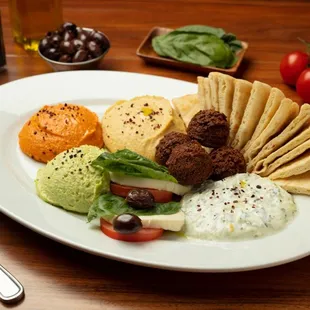 Appetizer Combo: Garbanzo, spicy, and edamame hummus, caprese, tzatziki, and falafels made to order.