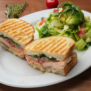 Salmon Brie Panini made to order with Atlantic salmon, brie cheese, Roma tomatoes, fresh dill, capers and red onions.