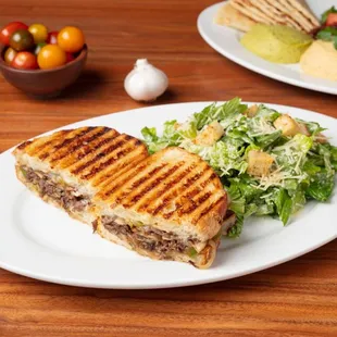 Steak Panini: Made to order with Flat Iron Steak, mushrooms, bell peppers, onions, Persian pickles, and provolone cheese.