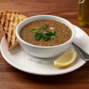 Vegan Green Lentil Soup: Broth with organic green lentils, tomatoes, garlic, red onion, parsley, mint, and crushed pepper.