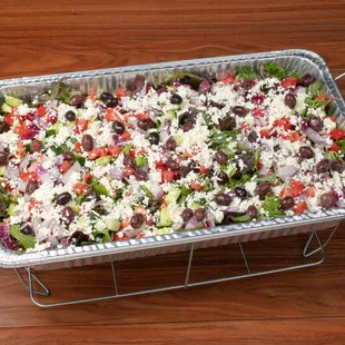 Mediterranean Greek Salad Catering Tray: mixed greens, feta cheese, diced tomatoes and cucumbers, and homemade balsamic dressing