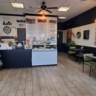 the inside of a restaurant with tables and chairs
