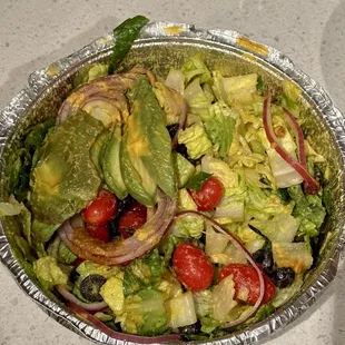 a salad in a tin foil container