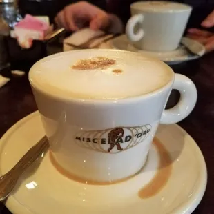 a cup of cappuccino on a saucer