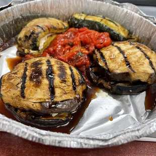 A6 Antipasti. Grilled eggplant and zucchini stuffed with goat cheese with roasted peppers and fig glaze. comes with fresh pita.