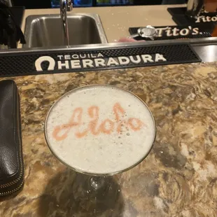 Pisco Sour, with Aloha written in Bitters