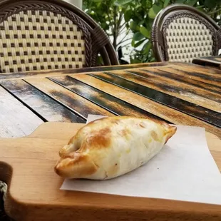 Empanada heated up, outside seating