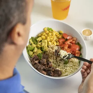 a man eating a bowl of food