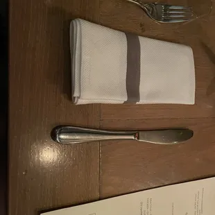 a fork, knife and napkin on a table