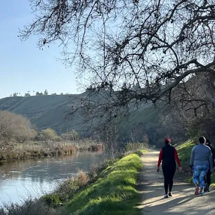 Walkers along the Carrier Canal at the base of the bluffs