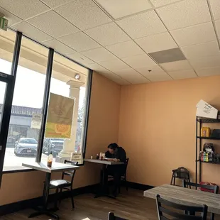 a woman sitting at a table in a restaurant