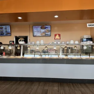 a restaurant counter with a variety of food items
