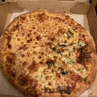 Half cheese and half cheese and basil pizza