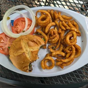 Ground beef burger and curly fries.