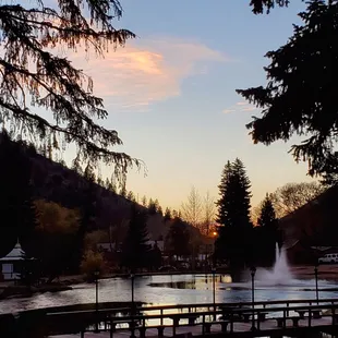 a pond with a fountain in the foreground