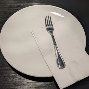 Plate with a fork and napkin