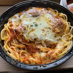 Veal parmigiana over spaghetti for take-out. Delicious and came piping hot!