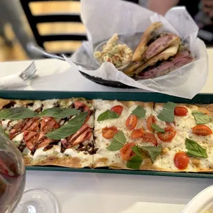 a pizza and a glass of wine