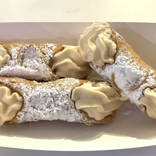 a pastry with cream and powdered sugar