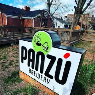 a sign in front of a brick building