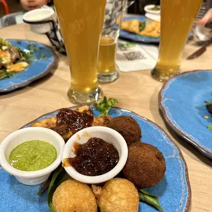 a plate of food and a glass of beer