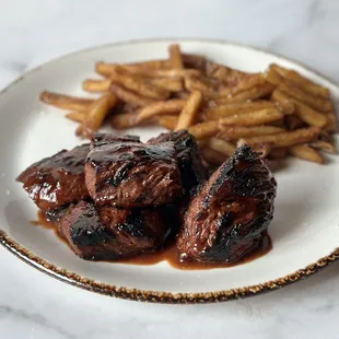 a plate of meat and french fries