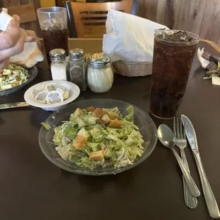 The portion of their salad is good the breads under the napkin over there