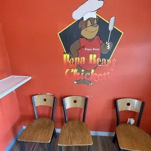 three chairs in front of a sign