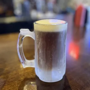 a glass of coffee on a table