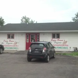 two cars parked in front of the restaurant