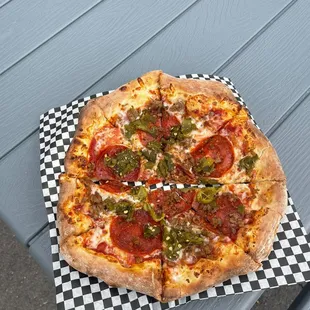 a pizza on a picnic table