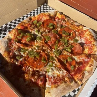 505 pizza with pepperoni, sausage, and green chilis
