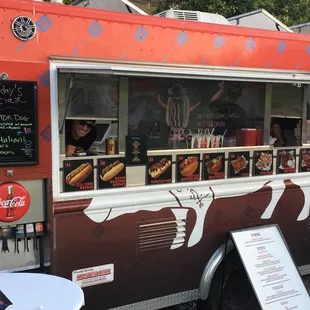 a food truck with a menu on the side