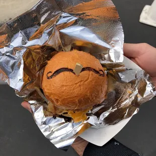 a hamburger with a face drawn on it