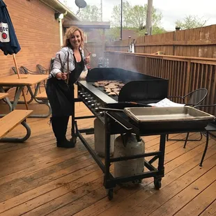 a woman cooking on a grill