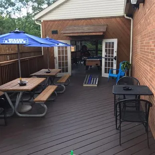 a patio with tables and umbrellas