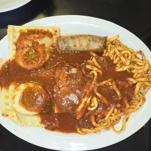 Spaghetti with huge raviolis, sausage and meatballs