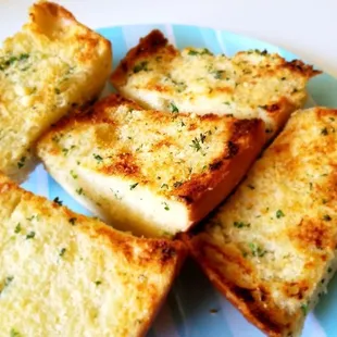 four slices of garlic bread on a plate