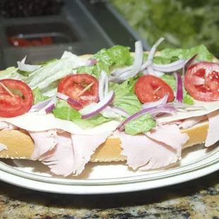 a sandwich with lettuce and tomatoes