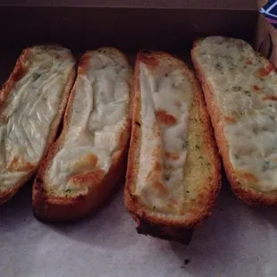 Cheesy Garlic Bread. Basically a Banh Mi roll sliced lengthwise into 4 pieces and topped with cheese &amp; garlic.