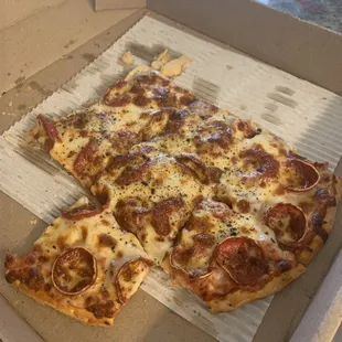 Medium pepperoni pizza, already half eaten.