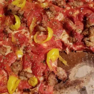 a pizza with peppers and sausage