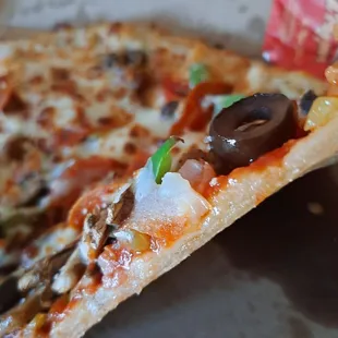 a slice of pizza with olives and cheese