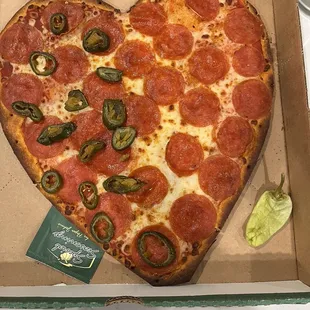 a heart shaped pepperoni pizza