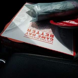 a box of pizza sitting on a car seat