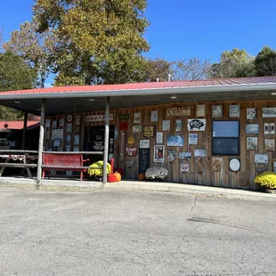 Exterior - entrance on left behind red bench.