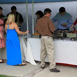 The buffet line with hungry guests.