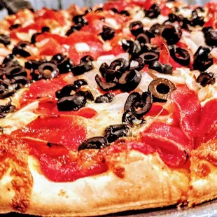 a pizza with pepperoni and olives
