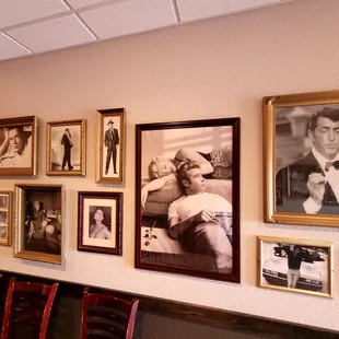 a wall full of framed photos